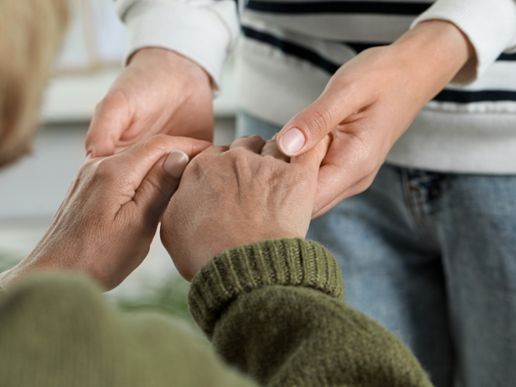 Family member supporting an elderly parent